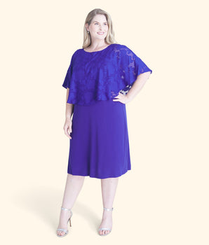 Woman posing wearing Deep Cobalt Alyssa Chiffon Burnout Cape Dress from Connected Apparel