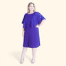 Woman posing wearing Deep Cobalt Alyssa Chiffon Burnout Cape Dress from Connected Apparel