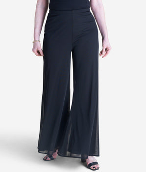 Woman posing wearing Black Sheri Black Palazzo Pant from Connected Apparel